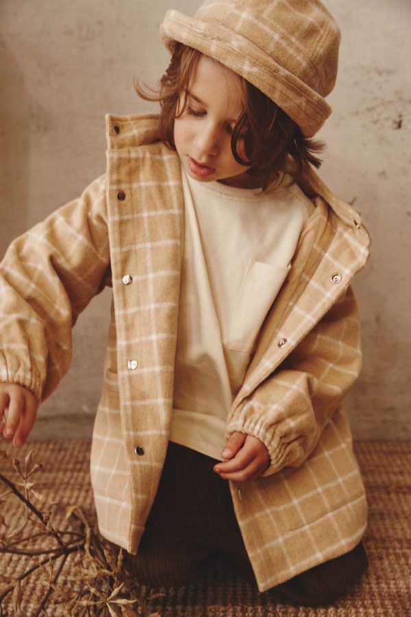 boy wearing the Joan Check Bucket Hat & Jacket in beige by the brand Alfred