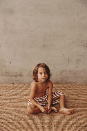 boy wearing the Lucia Shorts in Chocolate by the brand Alfred