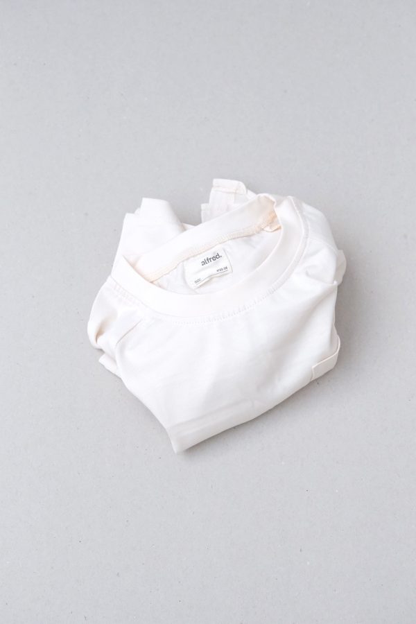 flatlay of the Walter Tee in Cream by the brand Alfred
