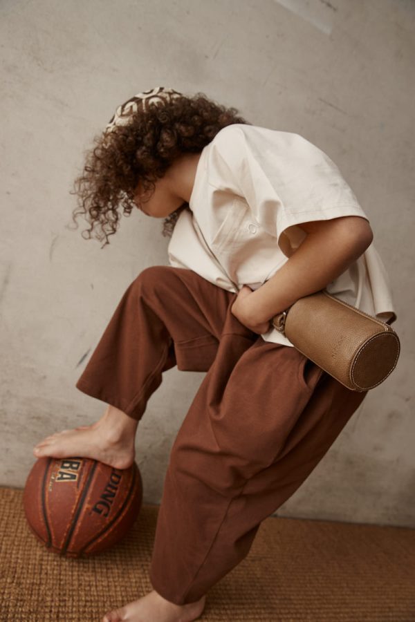 girl wearing the Walter Tee in Cream paired with the Boris Pants by the brand Alfred