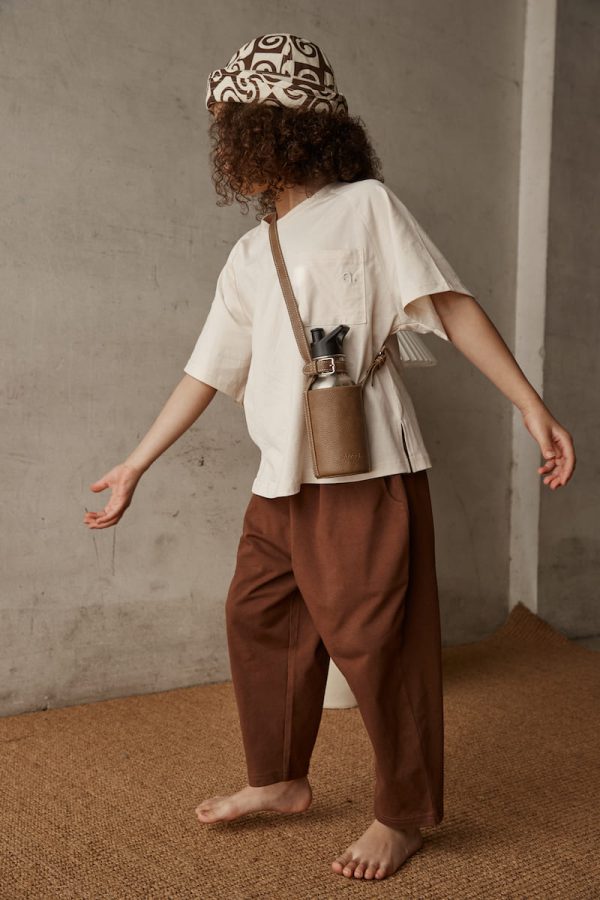 girl wearing the Walter Tee in Cream paired with the Boris Pants by the brand Alfred