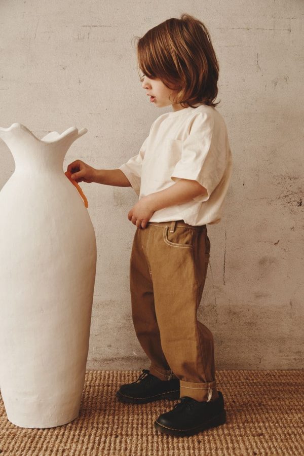 boy wearing the Walter Tee in Cream paired with the Arthur Worker Pants by the brand Alfred