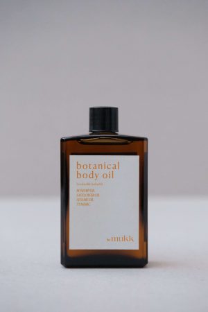Front view of the Botanical Body Oil by By Mukk showing the aesthetically pleasing product design with the ingredients listed on the front of the product