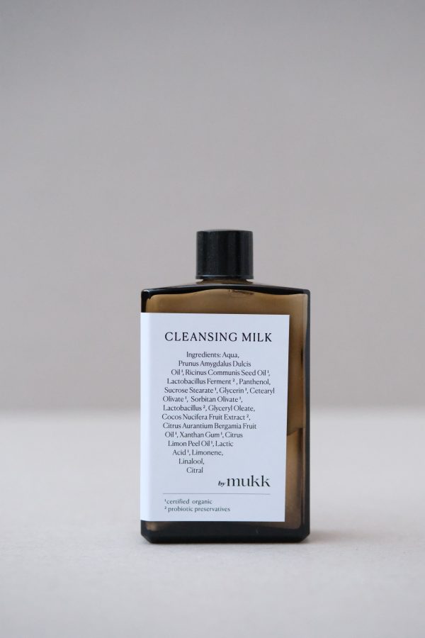 front view of the Cleansing Milk of By Mukk, showing the aesthetically pleasing product design with the ingredients listed on the front of the product