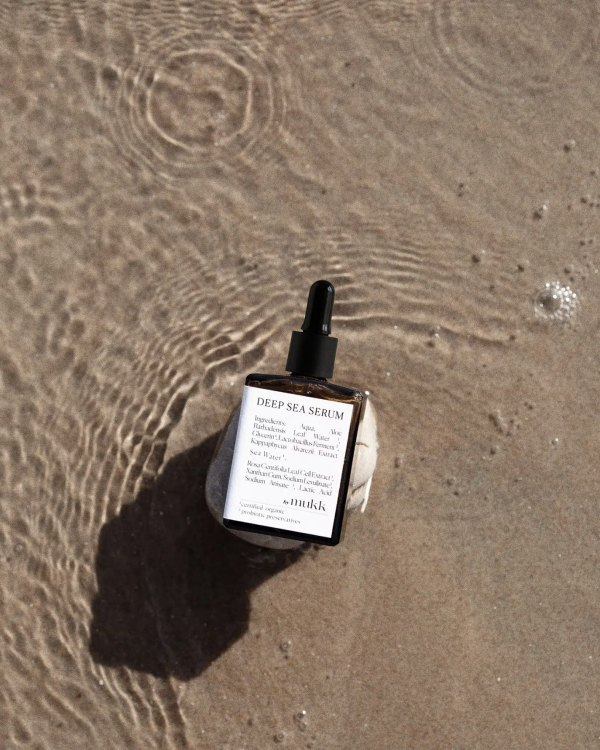 top view of the Deep Sea Serum by By Mukk placed on a stone at the beach, showing the designers' biggest inspiration for their product line