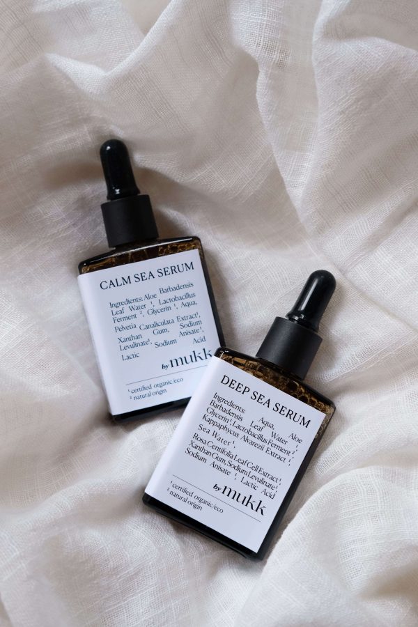 top view of both serum variations of By Mukk showing their aesthetically pleasing product design with the ingredients listed on the front of the products