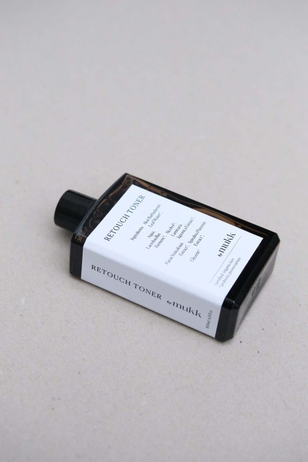 side view of the Retouch Toner of By Mukk, showing the aesthetically pleasing product design with the ingredients listed on the front of the product