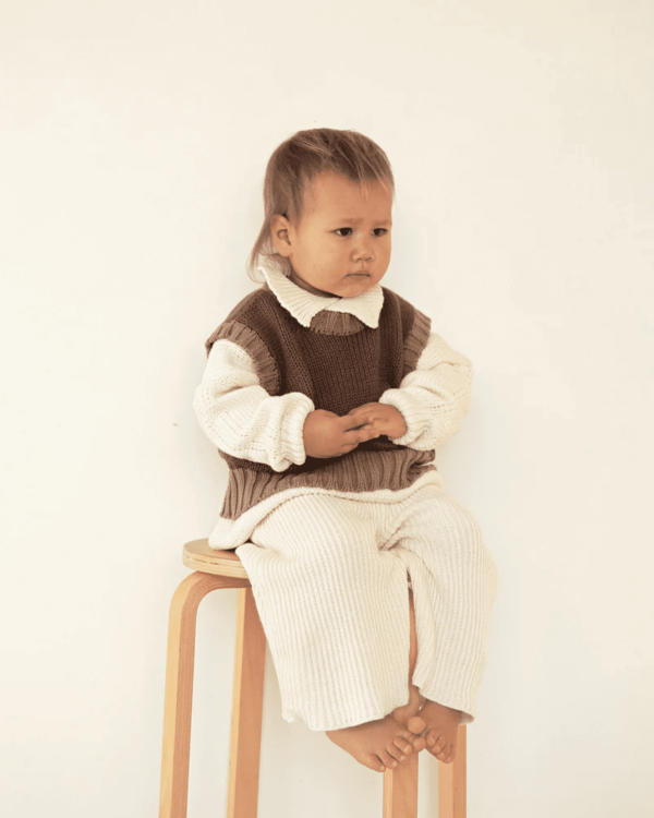 the Knitted Vest in Coco with Brownie Trim paired with the collared knit & wide knit pants in cream by the brand Summer and Storm