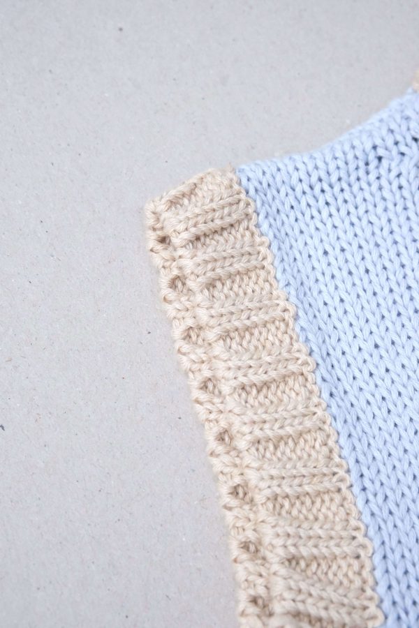 the Knitted Vest in Powder Blue with Natural Trim by the brand Summer and Storm