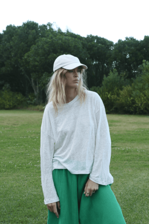 the linen longsleeve tee in white paired with the Wide Knit Pants in Emerald by the brand Summer and Storm