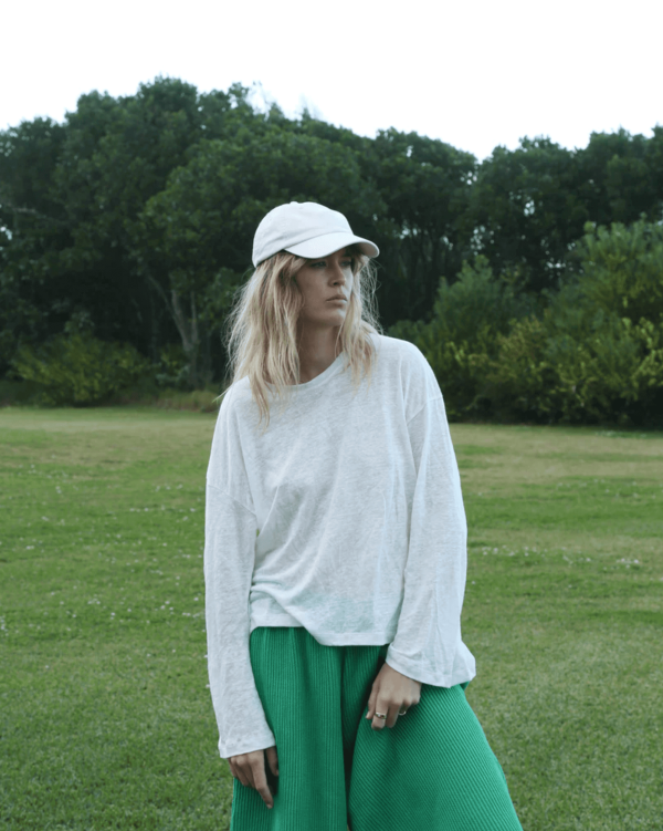 the linen longsleeve tee in white paired with the Wide Knit Pants in Emerald by the brand Summer and Storm