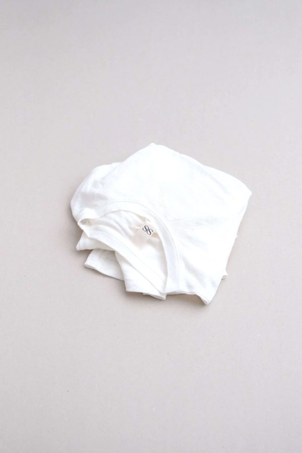 flatlay of the linen longsleeve tee in white by the brand Summer and Storm