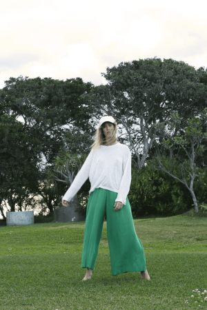 the linen longsleeve tee in white paired with the wide knit pants in emerald by the brand Summer and Storm