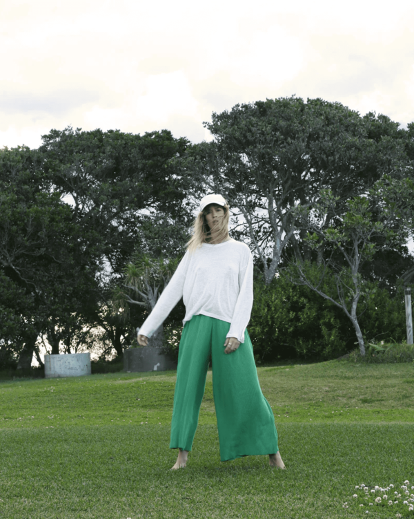 the linen longsleeve tee in white paired with the wide knit pants in emerald by the brand Summer and Storm