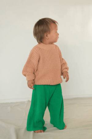 the wide knit pants in emerald paired with the chunky pullover by the brand Summer and Storm