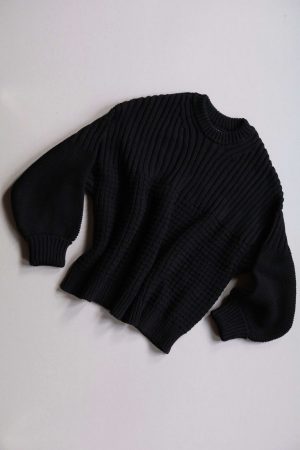 the Delcia Sweater in Black by the brand The Knotty Ones