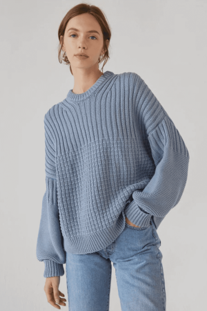 woman wearing the Delcia Sweater in Blue by the brand The Knotty Ones