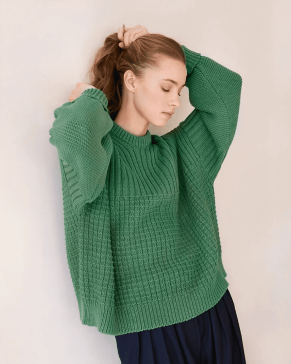 woman wearing the Delcia Sweater in Fern Green by the brand The Knotty Ones