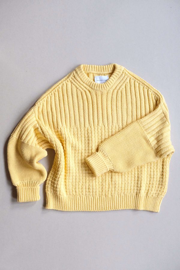 the Delcia Sweater in Lemon by the brand The Knotty Ones