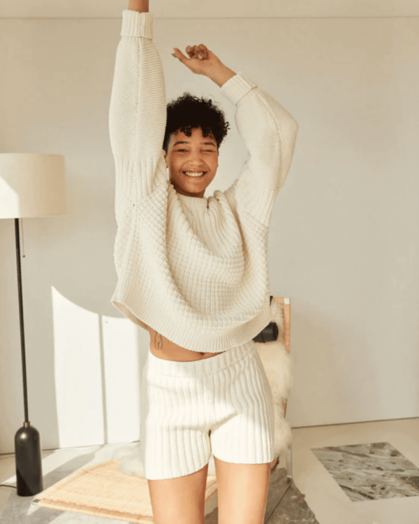woman wearing the Delcia Sweater in Off-White by the brand The Knotty Ones