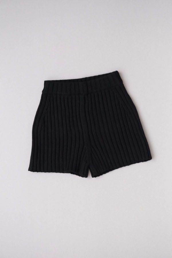 flatlay of the Pilnatis Shorts in Black by the brand The Knotty Ones