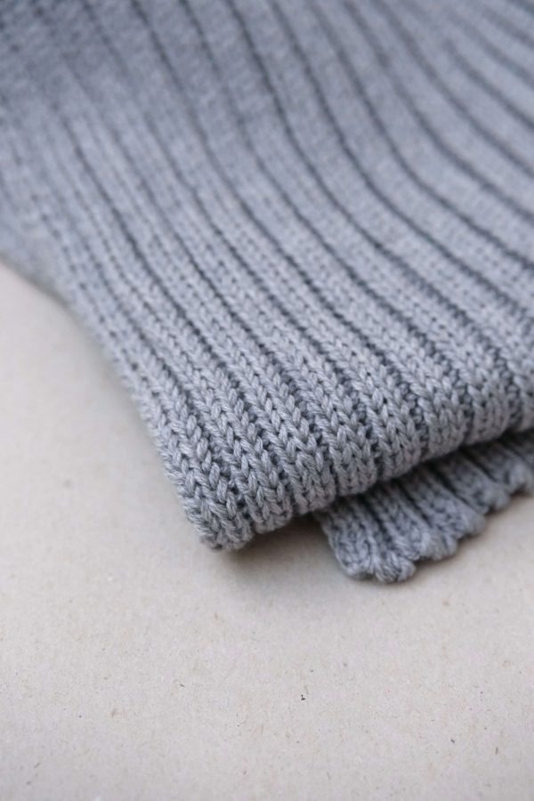 the knitted Rib Scarf in Grey by the brand The Knotty Ones