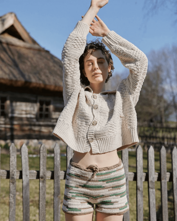 the knitted Zemelapis Shorts in Land paired with the Prietema Cardigan by the brand The Knotty Ones