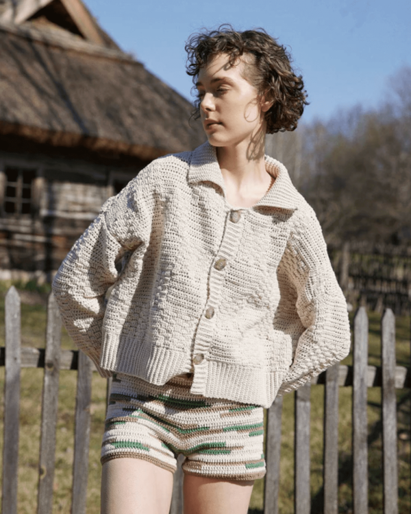 the knitted Zemelapis Shorts in Land paired with the Prietema Cardigan by the brand The Knotty Ones