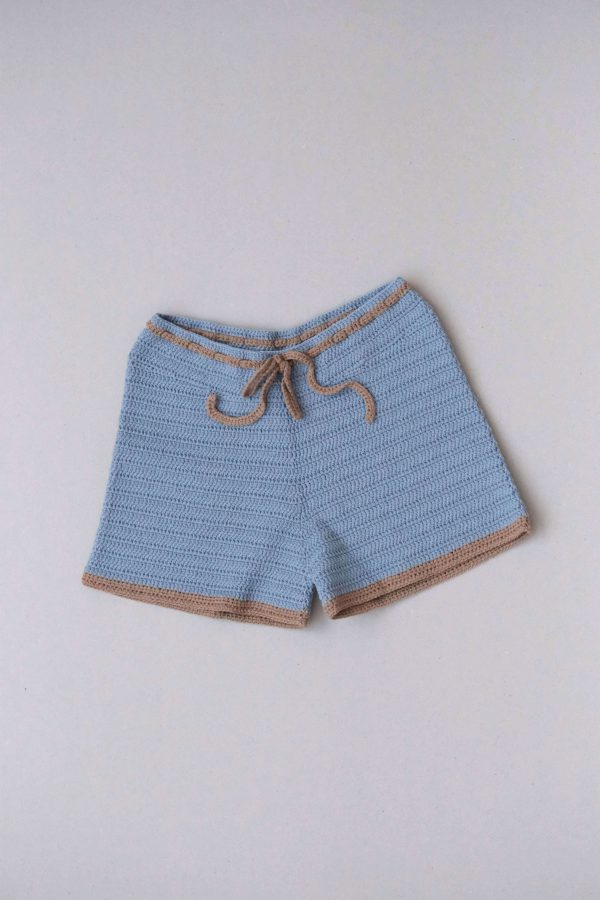 flatlay of the Zemelapis Shorts in Sea by the brand The Knotty Ones