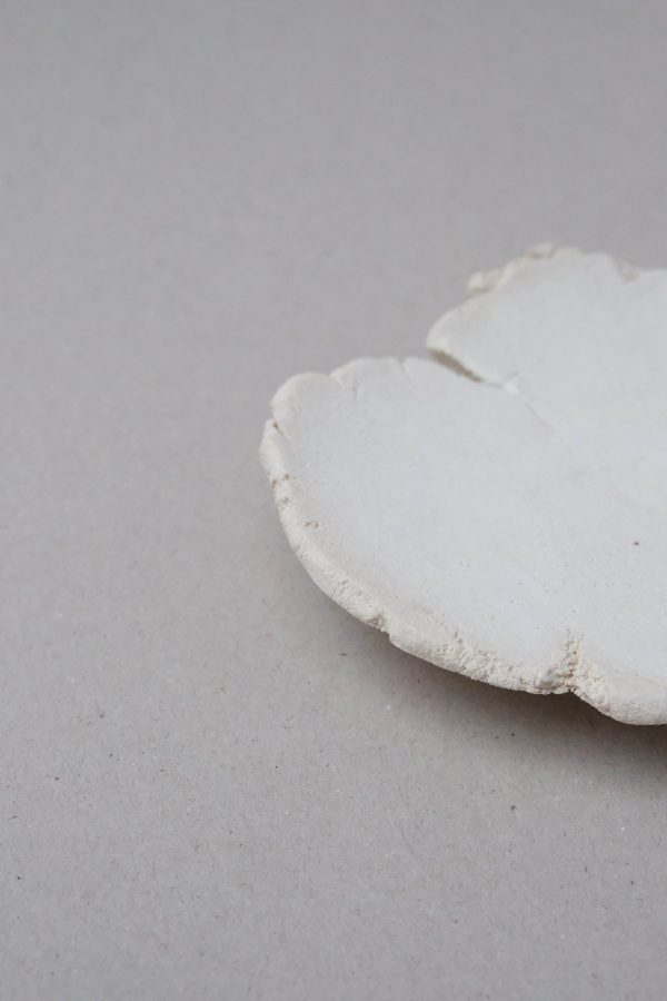 Showing the delicate and imperfect curves of the ceramic Moon Tray Love by Marlies Huybs