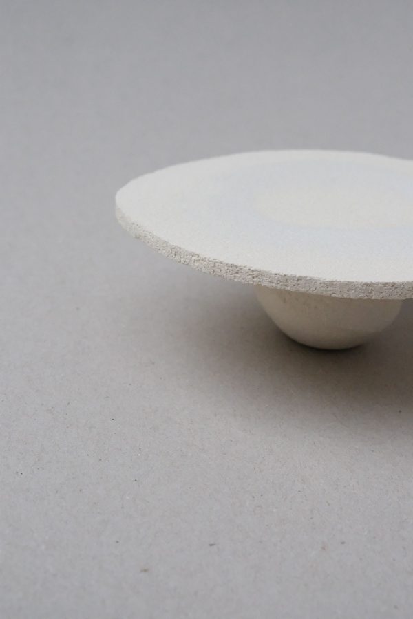 Side view of the ceramic Moon Tray Satelite by Marlies Huybs, showing the textured edges and beautiful juxtaposition of tray and sole