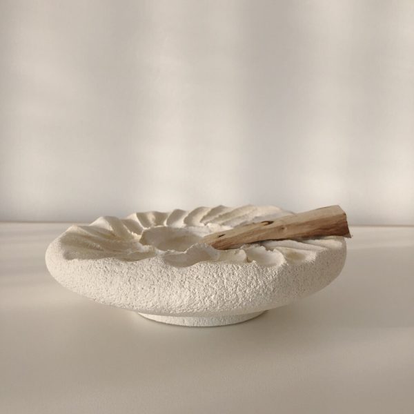 Side view of the Siipi Tray by Marlies Huybs showing the floating tray on a smaller sole styled with palo santo
