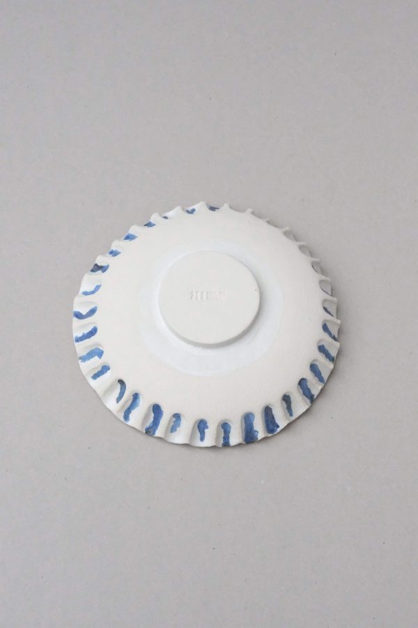 Bottom view of the ceramic XL Moon Bowl Anemone by Marlies Huybs showing the textural and blue pattern on the edges
