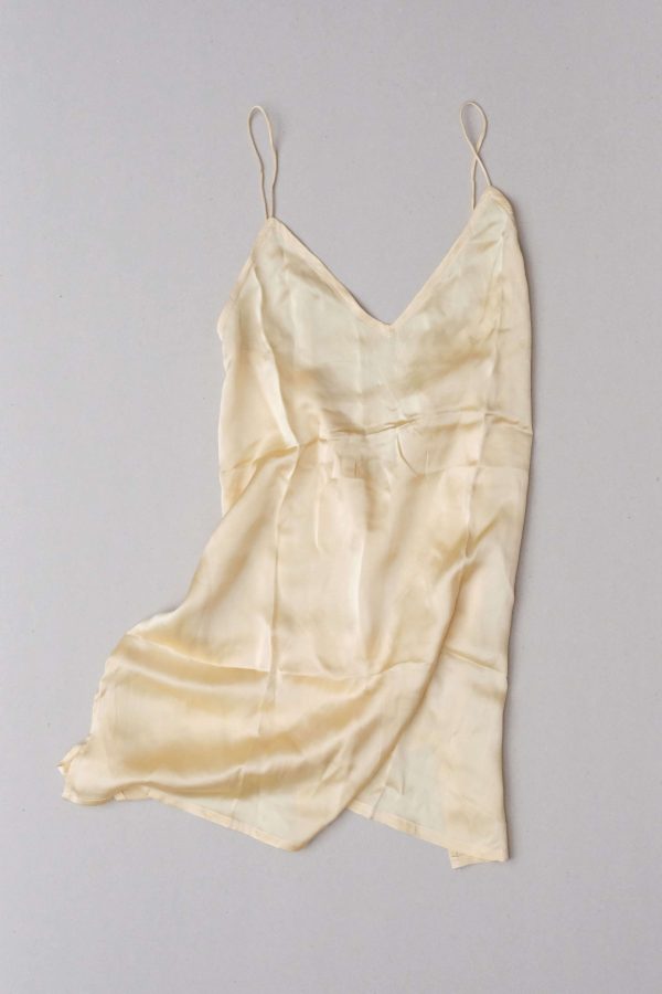 front flatlay of the Jai Dress in Yellow by the brand Bahhgoose, showing the straps and the soft silky fabric of the dress