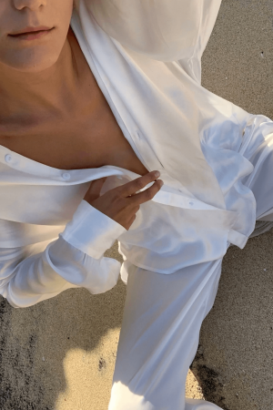 woman wearing the Jai Pants in White with the matching button up, by the brand Bahhgoose