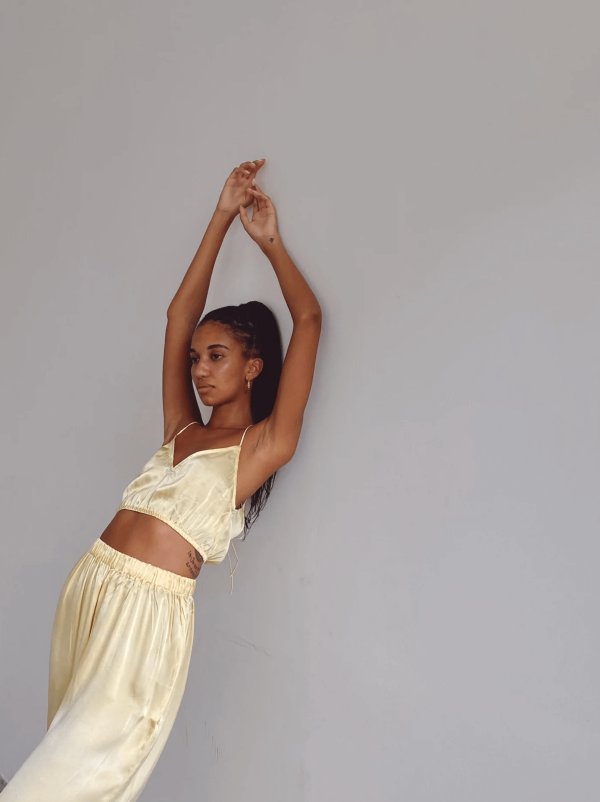 a woman wearing the Jai Top with the matching Jai Pants in Yellow by the brand Bahhgoose, showing the relaxed fit of this beautiful co-ord set