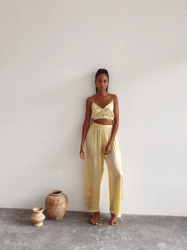 a woman wearing the Jai Top with the matching Jai Pants in Yellow by the brand Bahhgoose, showing the relaxed fit of this beautiful co-ord set