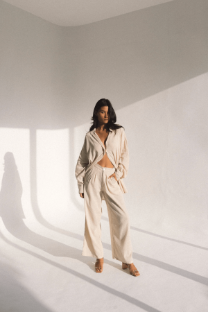 woman wearing the Ker Button Up with the matching Ker Trouser in Natural by the brand Bahhgoose, showing the relaxed fit of this beautiful co-ord set