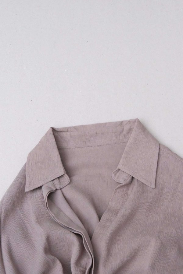 flatlay of the Ker Button Up in Taupe by the brand Bahhgoose, showing the collar detail