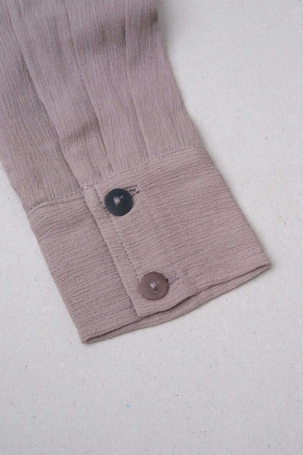 flatlay of the Ker Button Up in Taupe by the brand Bahhgoose, showing the sleeve detail