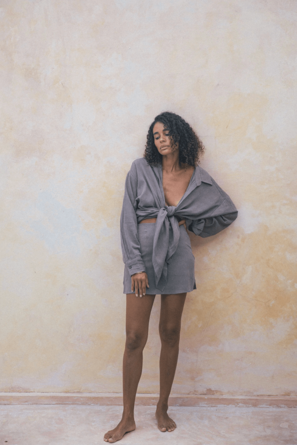 woman wearing the Ker Button Up in Taupe with the matching Ona Skirt by the brand Bahhgoose, showing the relaxed fit of this beautiful co-ord set
