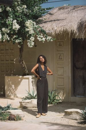 woman wearing the Ker Trousers in charcoal with the matching Ona Button Up by the brand Bahhgoose, showing the relaxed fit of this beautiful co-ord set