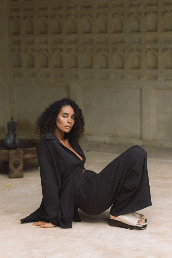 woman wearing the Ker Trousers in charcoal with the matching Ker Button Up by the brand Bahhgoose, showing the relaxed fit of this beautiful co-ord set