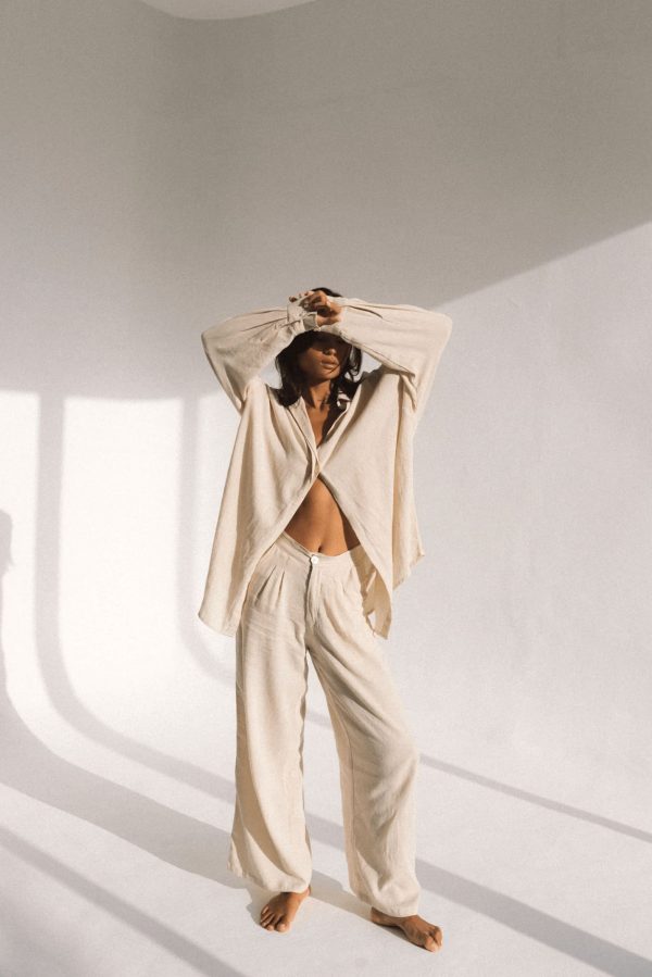 woman wearing the Ker Trousers with the matching Ker Button Up in Natural by the brand Bahhgoose, showing the relaxed fit of this beautiful co-ord set