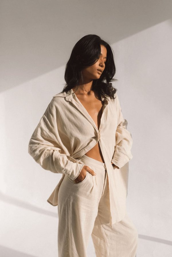 woman wearing the Ker Trousers with the matching Ker Button Up in Natural by the brand Bahhgoose, showing the relaxed fit of this beautiful co-ord set