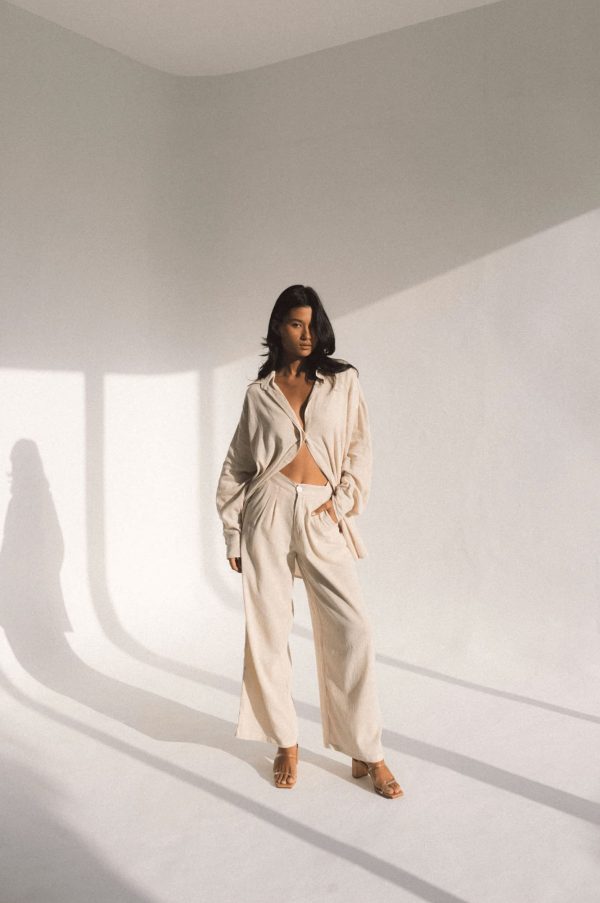 woman wearing the Ker Trousers with the matching Ker Button Up in Natural by the brand Bahhgoose, showing the relaxed fit of this beautiful co-ord set