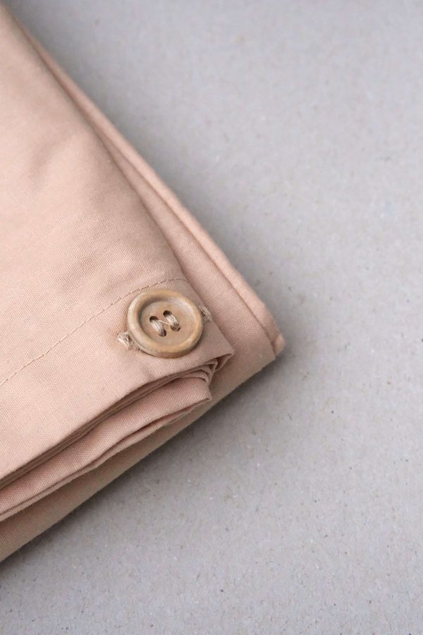 flatlay of the Base Cotton Duvet Set in Nude Pink by the brand Cats and Boys