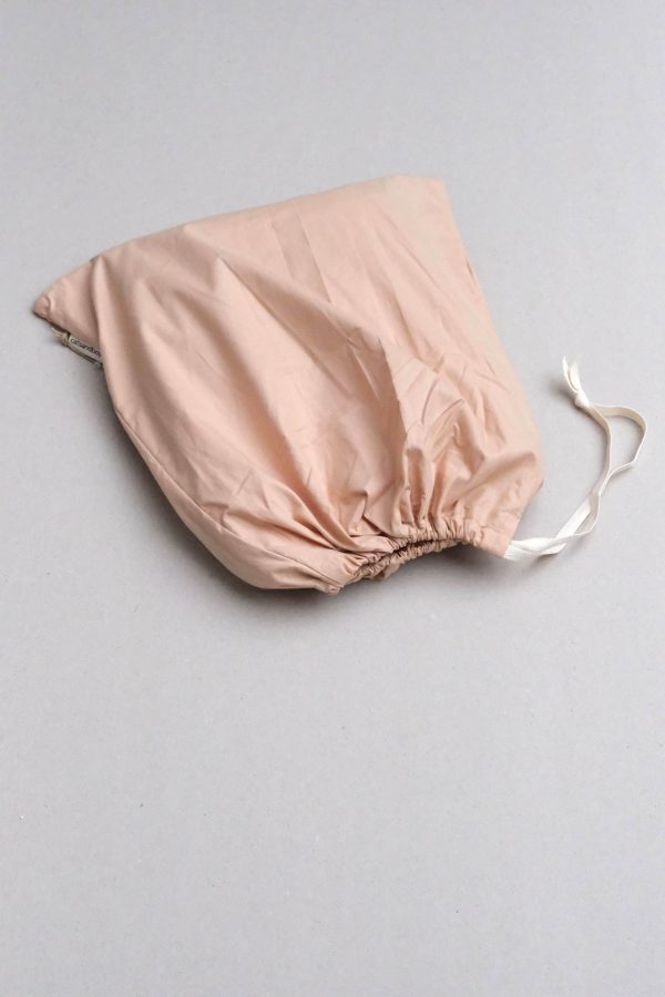 flatlay of the Base Cotton Fitted Bedsheet in Nude Pink by the brand Cats and Boys