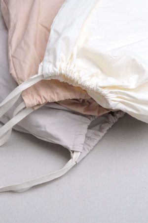flatlay of the Base Cotton Fitted Bedsheets in Nude Pink,Sand & Vanilla by the brand Cats and Boys