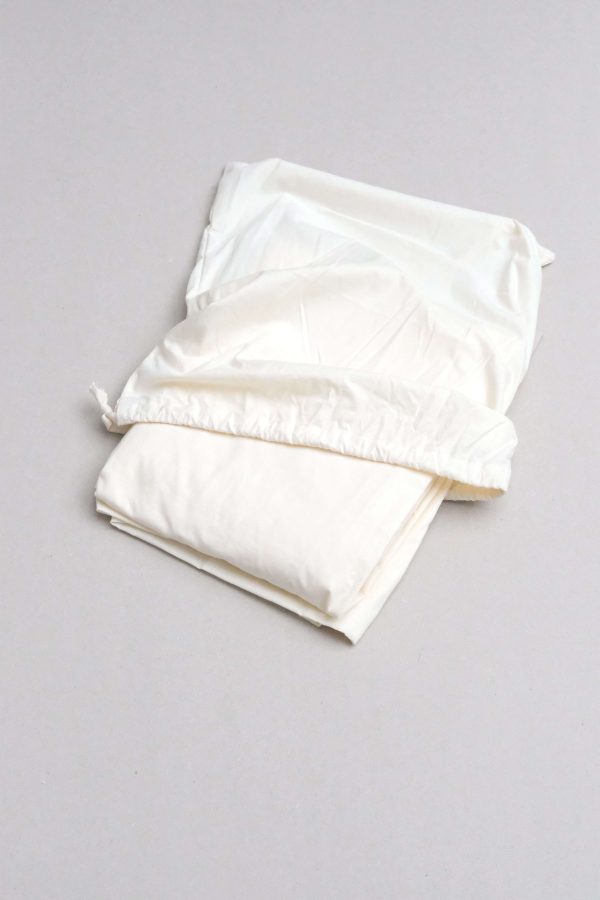 flatlay of the Base Cotton Fitted Bedsheet in Vanilla by the brand Cats and Boys